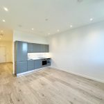 Modern kitchen in a spacious, empty flat.