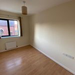 Empty room with wooden floor and window.