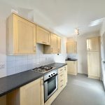 Modern kitchen with wooden cabinets and gas hob.