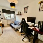 Cosy home office with desk and sofa bed.