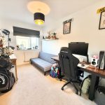 Home office with gaming desk and LEGO displays.