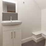 Modern bathroom with sink and toilet.