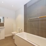 Modern bathroom with bathtub and sink.