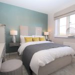 Modern bedroom with double bed and teal accent wall