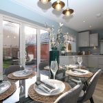 Modern kitchen with dining table and garden view