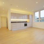 Modern kitchen with wooden flooring and large windows