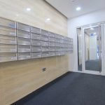 Modern apartment building entrance with mailboxes.