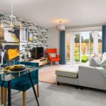 Modern living room with garden view and teal accents.