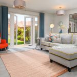 Bright living room with garden view through doors.