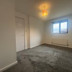 Empty room with window and carpet flooring