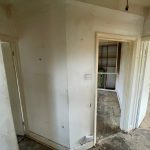 Empty hallway with open doors to rooms