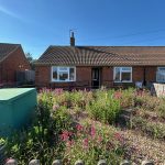 Brick bungalow with garden and flowers