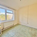 Empty room with window and insulation roll