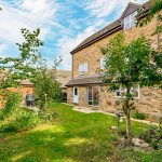 Brick house with garden and trees