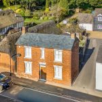 Aerial view of a quaint English village street.