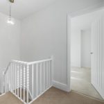 Bright hallway with open doors and staircase