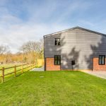 Modern house with garden and wooden fence