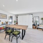 Modern dining room with wooden table and chairs.