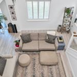 Spacious living room with modern grey furniture.