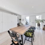 Modern dining room with wooden table and chairs.