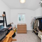 Home office with laptop and clothes storage