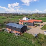 Aerial view of countryside buildings and fields