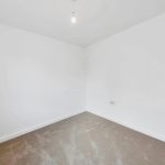 Empty white room with beige carpet