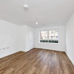 Empty room with wooden floor and window