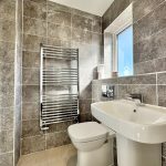 Modern bathroom with sink and toilet.