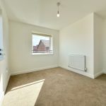 Bright empty room with carpet and radiator