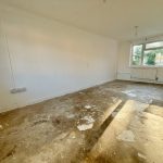 Empty room with bare floor and window view.
