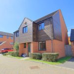 Modern detached house with garage and driveway.