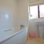 Bright bathroom with tub and sink.