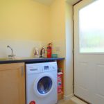 Utility room with washing machine and sink