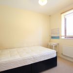 Small bedroom with double bed and window