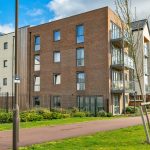 Modern apartment building with balconies and trees