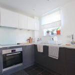 Modern kitchen with white and grey cabinets.