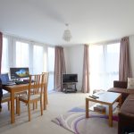Bright modern living room with furniture and decor.