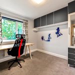 Modern study room with desk and wall art.
