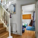 Wooden staircase and cosy bedroom view.