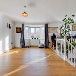 Spacious room with dartboard and exercise equipment.