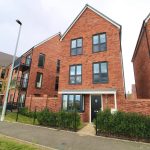 Modern red-brick houses with black framed windows.