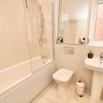Modern bathroom with shower and window.