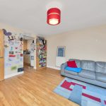 Cosy living room with sofa and children’s artwork