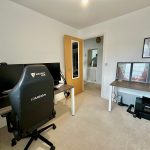 Home office with gaming chair and dual monitors