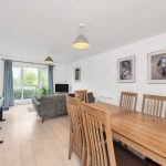 Modern living room with dining area and large window