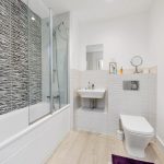 Modern bathroom with shower and striped tiles.