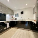 Modern kitchen with sleek black cabinets.