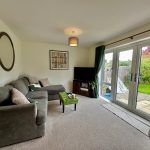 Bright living room with garden view and comfy sofa.
