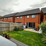Modern red-brick house with garden view.